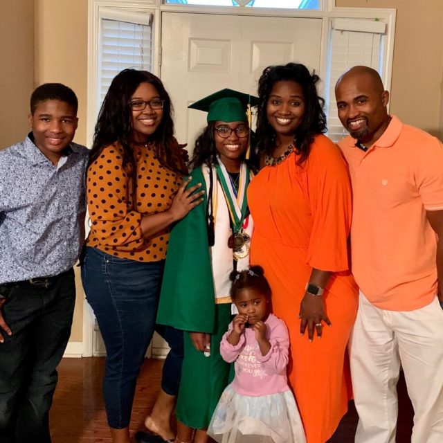 Family with graduate smiling at camera