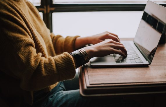 person sitting front of laptop